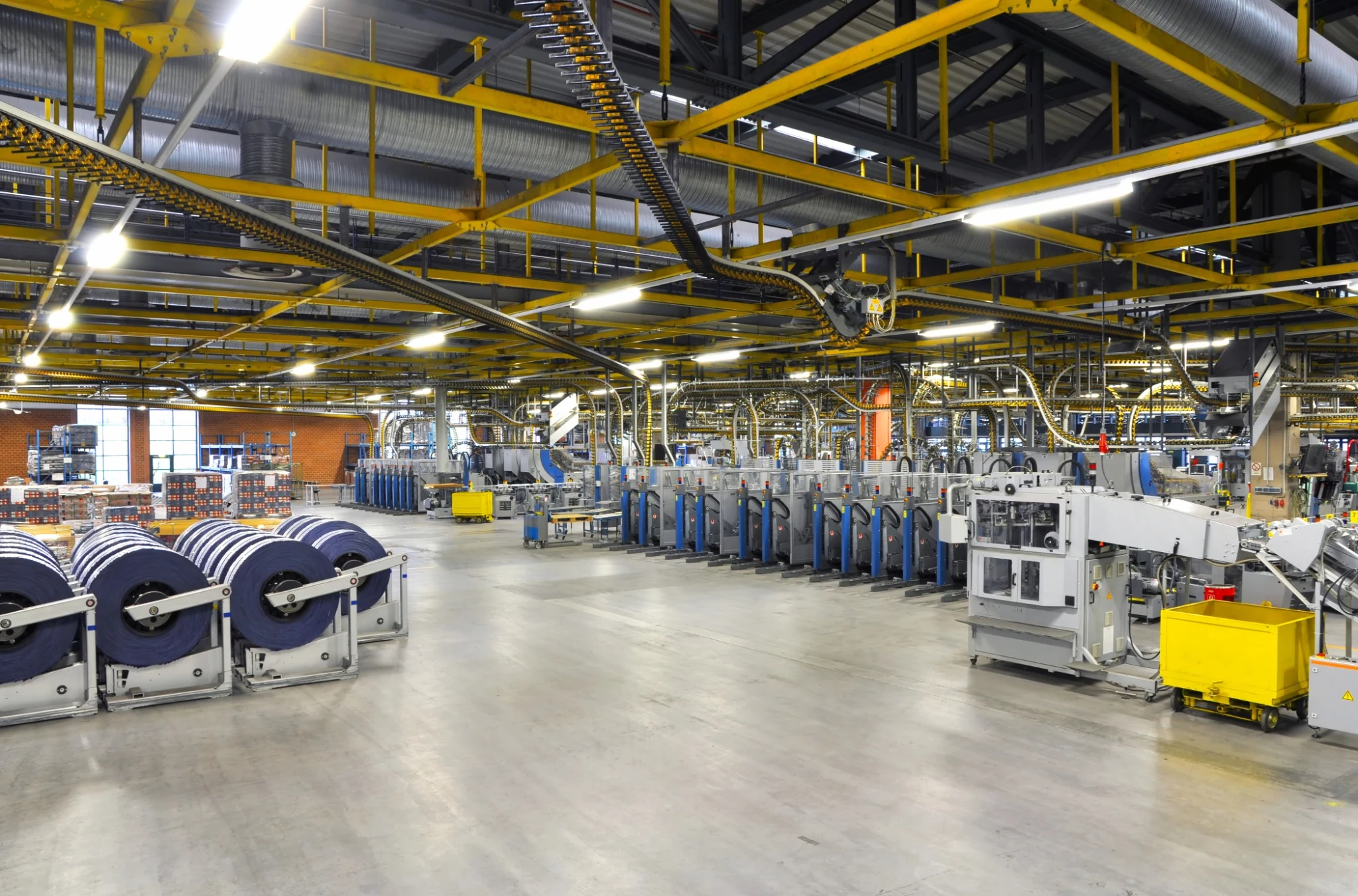 Wide view of a modern manufacturing facility with industrial equipment and production lines.